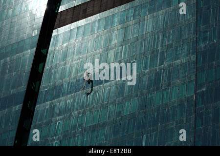 A Man Cleaning Windows On A High Rise Building Stock Photo