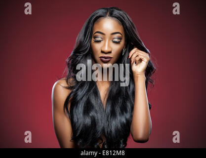 Black beautiful woman with long luxurious shiny hair Stock Photo