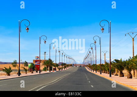 Horizontal view of a straight section of the N9 highway heading towards the Atlas Mountain range in Morocco. Stock Photo