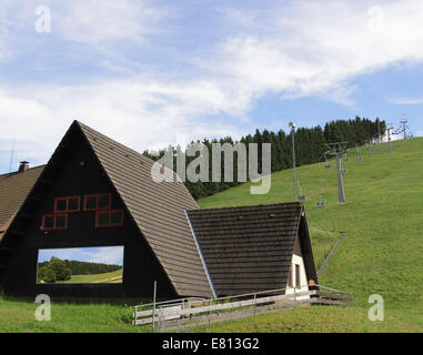 Typical facade of an Apline challet with a plasma TV screen Stock Photo