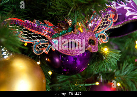 Horizontal close up of brightly coloured ornamental Christmas decorations on the real pine tree. Stock Photo