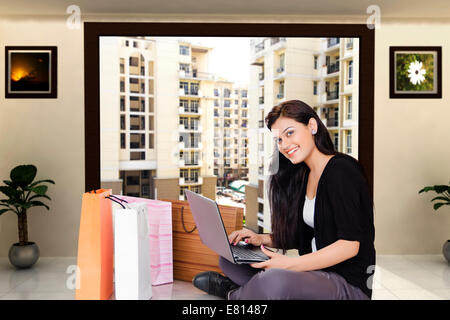 indian Beautiful Ladies online shopping with laptop Stock Photo