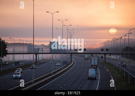 fog and rising sun in the morning on highway A28 near Utrecht De Uithof Stock Photo