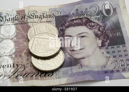 British £20 pounds note with 10p coins Stock Photo