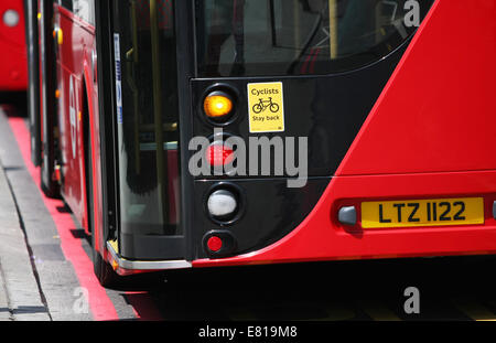 A rear view of parts of two red London buses traveling in London. Stock Photo