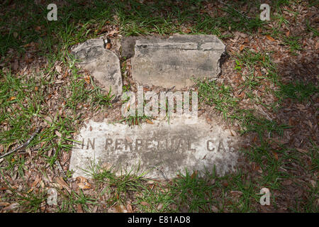 Grave marker with phrase "In Perpetual Care" with no grave stone and broken support. Stock Photo