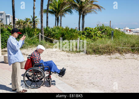 Miami Beach Florida,man men male,adult son,senior seniors citizen citizens,elderly,wheelchair,old,FL140305044 Stock Photo