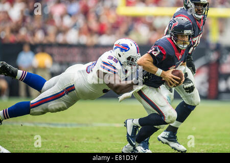 Buffalo Bills defensive tackle Marcell Dareus, center, passes Baltimore  Ravens tackle Michael Oher (74) to sack Ravens quarterback Joe Flacco (5)  during the second quarter at Ralph Wilson Stadium in Orchard Park