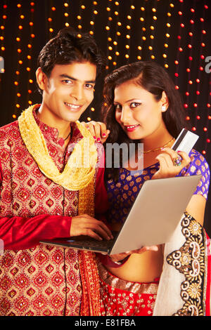indian couple  diwali Festival Shopping  with laptop Stock Photo