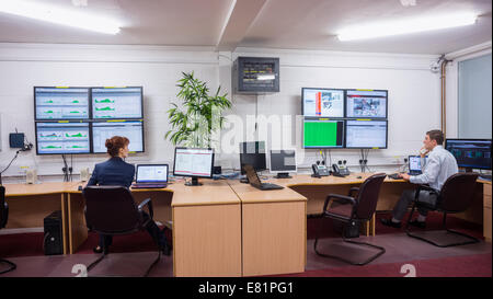 Technicians sitting in office running diagnostics Stock Photo