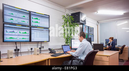 Technician sitting in office running diagnostics Stock Photo