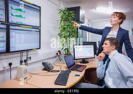 Focused colleagues analyzing result on their computer Stock Photo
