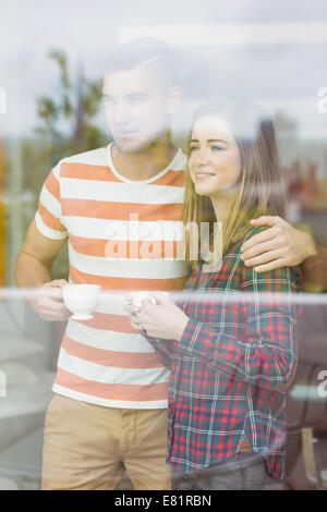 Cute couple looking out the window Stock Photo