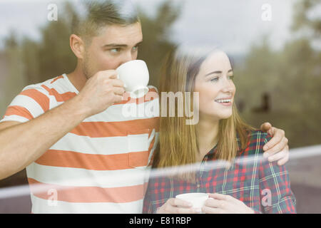 Cute couple looking out the window Stock Photo