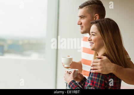 Cute couple looking out the window Stock Photo