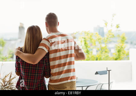 Cute couple looking out the window Stock Photo