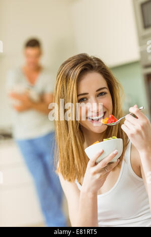 Woman eating fruit salad at breakfast Stock Photo