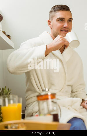 Man drinking coffee in his bathrobe Stock Photo