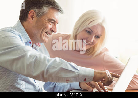 Happy mature couple using laptop Stock Photo