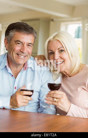 Happy mature couple drinking red wine Stock Photo