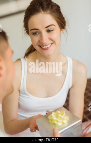 Man giving his pretty girlfriend a gift Stock Photo