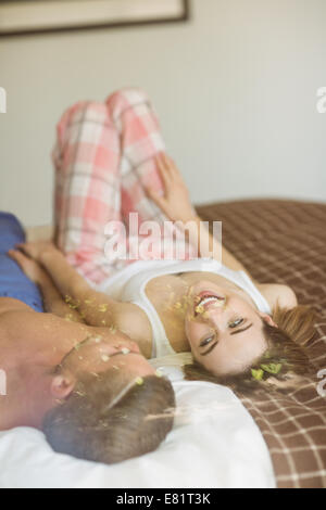 Cute couple lying on bed Stock Photo