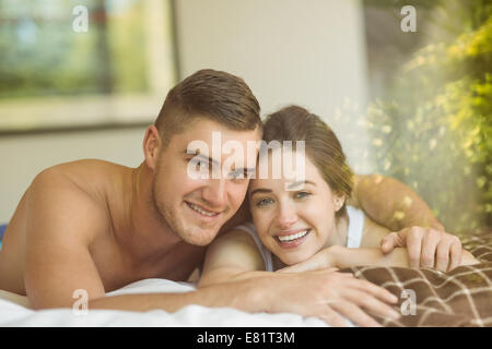 Cute couple lying on bed Stock Photo