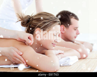 Composite image of loving couple having an acupunctre therapy Stock Photo