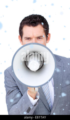 Composite image of angry businessman shouting through a megaphone Stock Photo