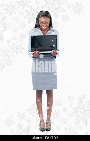 Composite image of portrait of a businesswoman showing a laptop Stock Photo