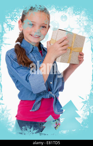 Composite image of portrait of a happy girl holding a gift box Stock Photo