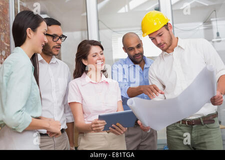 Architect colleagues working on blueprints and digital tablet Stock Photo