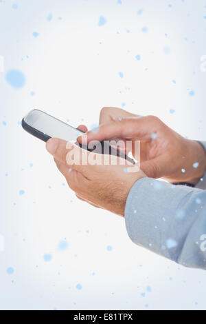 Composite image of hands using mobile phone Stock Photo