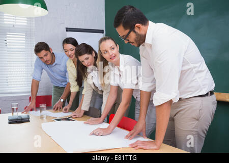 Team of architects going over blueprints Stock Photo