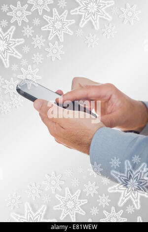 Composite image of hands using mobile phone Stock Photo