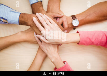 Business people putting their hands together on the table Stock Photo