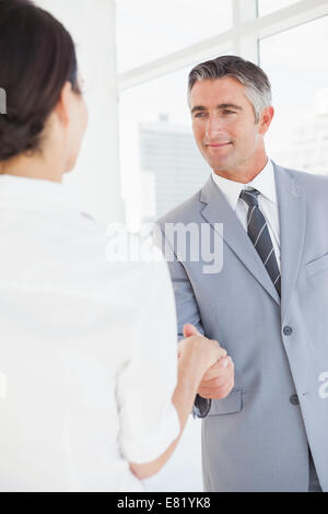 Businessman shaking co workers hand Stock Photo