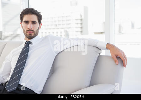 Concentrated businessman sitting on couch Stock Photo