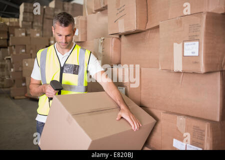 Worker scanning package in warehouse Stock Photo
