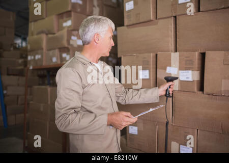Worker scanning package in warehouse Stock Photo