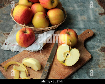 Red apples on cutting board in the kitchen Stock Photo