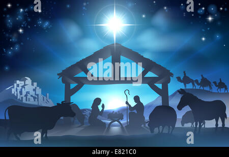 Traditional Christian Christmas Nativity Scene of baby Jesus in the manger with Mary and Joseph in silhouette surrounded by the Stock Photo