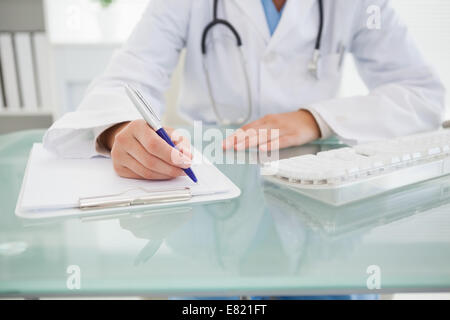 Doctor writing down some notes Stock Photo