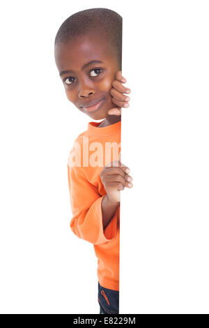 Cute boy looking around corner Stock Photo