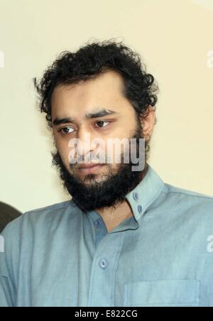 Bangladeshi police present Samiun Rahman , a British citizen of Bangladeshi origin, on suspicion of ties with global jihadist organizations in Dhaka on September 29, 2014. Bangladesh police said September 29 they arrested a British citizen suspected of entering the country to recruit militants for jihadist groups overseas such as the Islamic State organization. Stock Photo