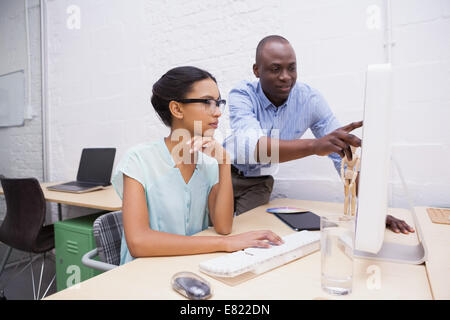 Man showing something to his colleague on the laptop Stock Photo