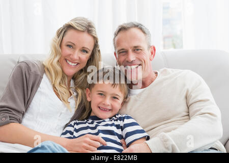 Parent cuddling their son on the couch Stock Photo
