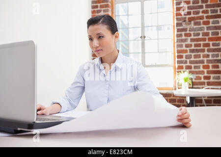 Casual architect using her laptop Stock Photo