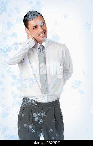 Portrait of a young businessman having a back pain Stock Photo