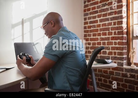 Casual photographer looking at his camera Stock Photo